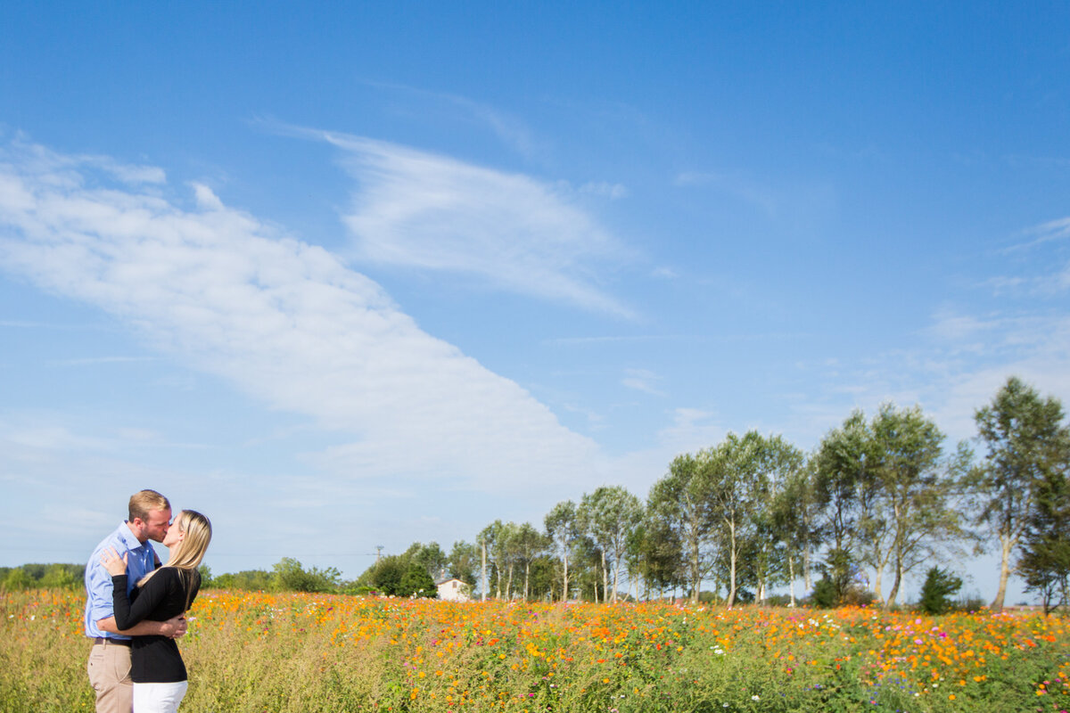 Man and woman in a field of yellow flowers