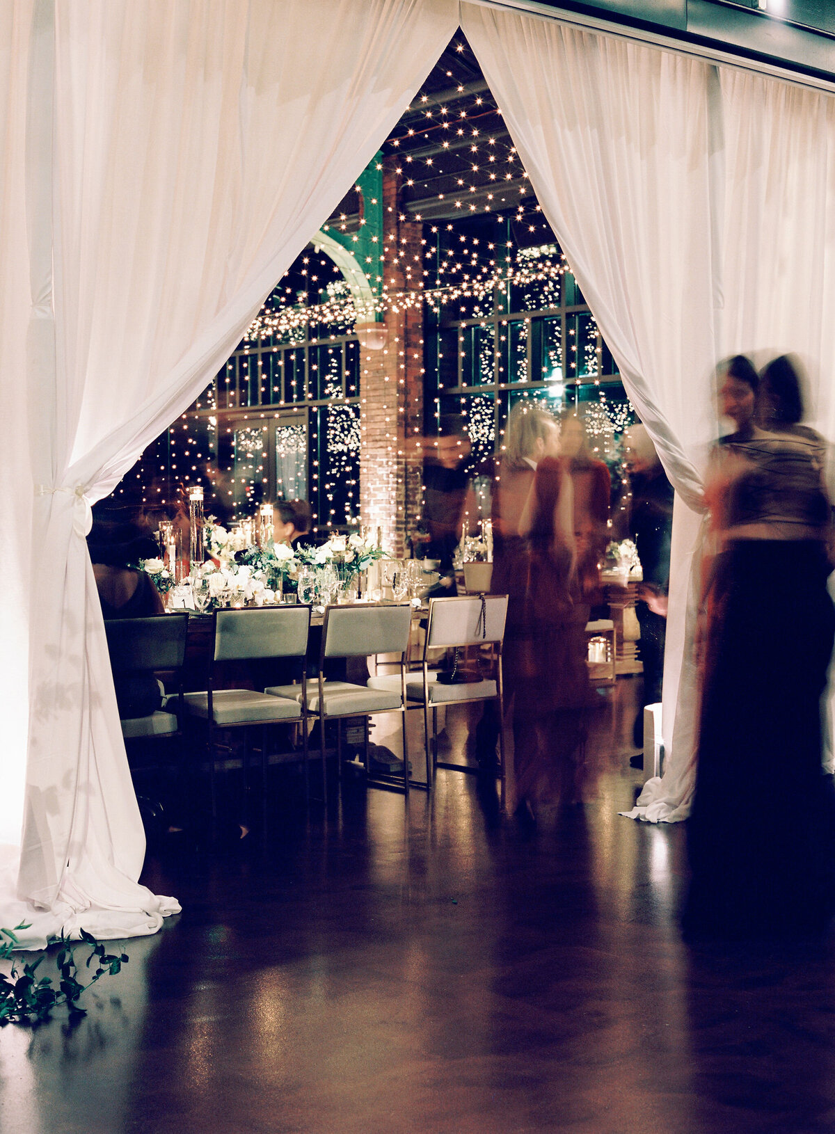 A blurred photo of guests at the wedding reception. 