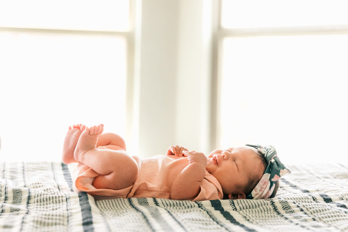 Backlit baby in front of window