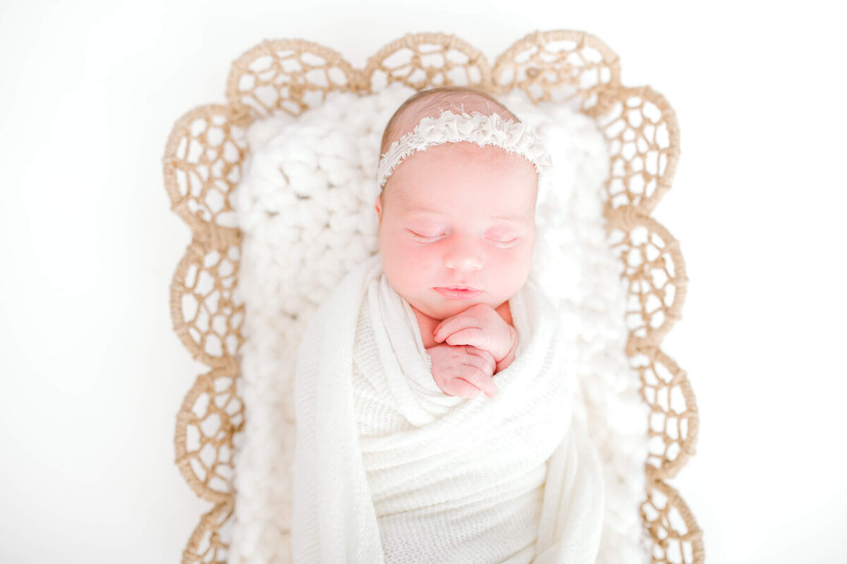 Baby in a dreamcatcher bowl accented in white lace