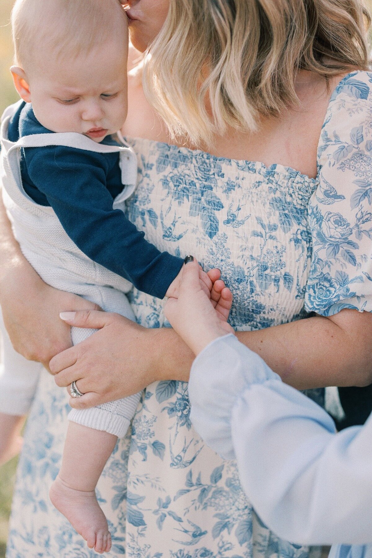 mom-holding-son-kissing-his-head