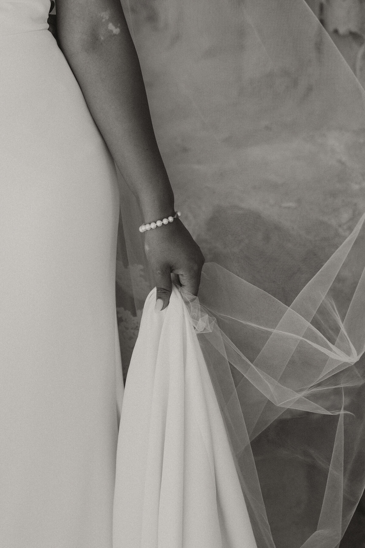 bride holding dress and veil 