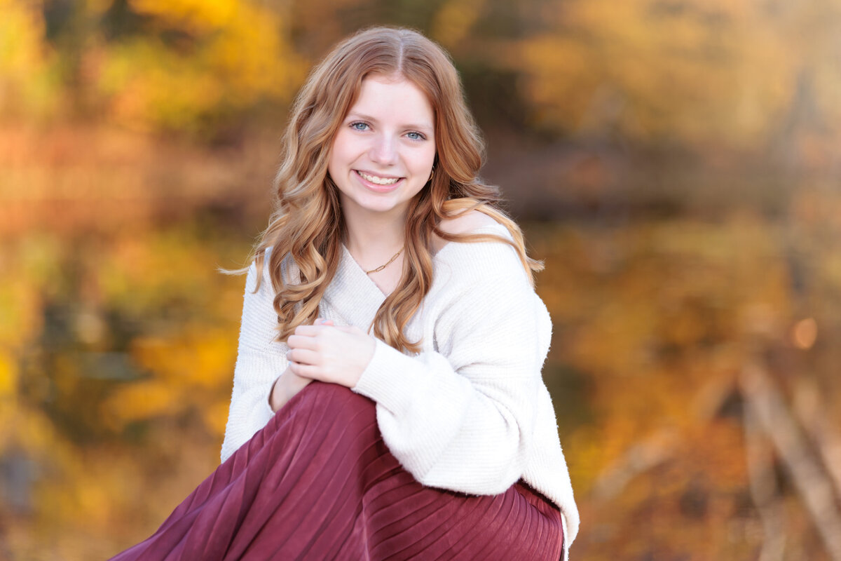 Fall colors reflecting in the pond for this Teen's portraits in Raleigh, NC.