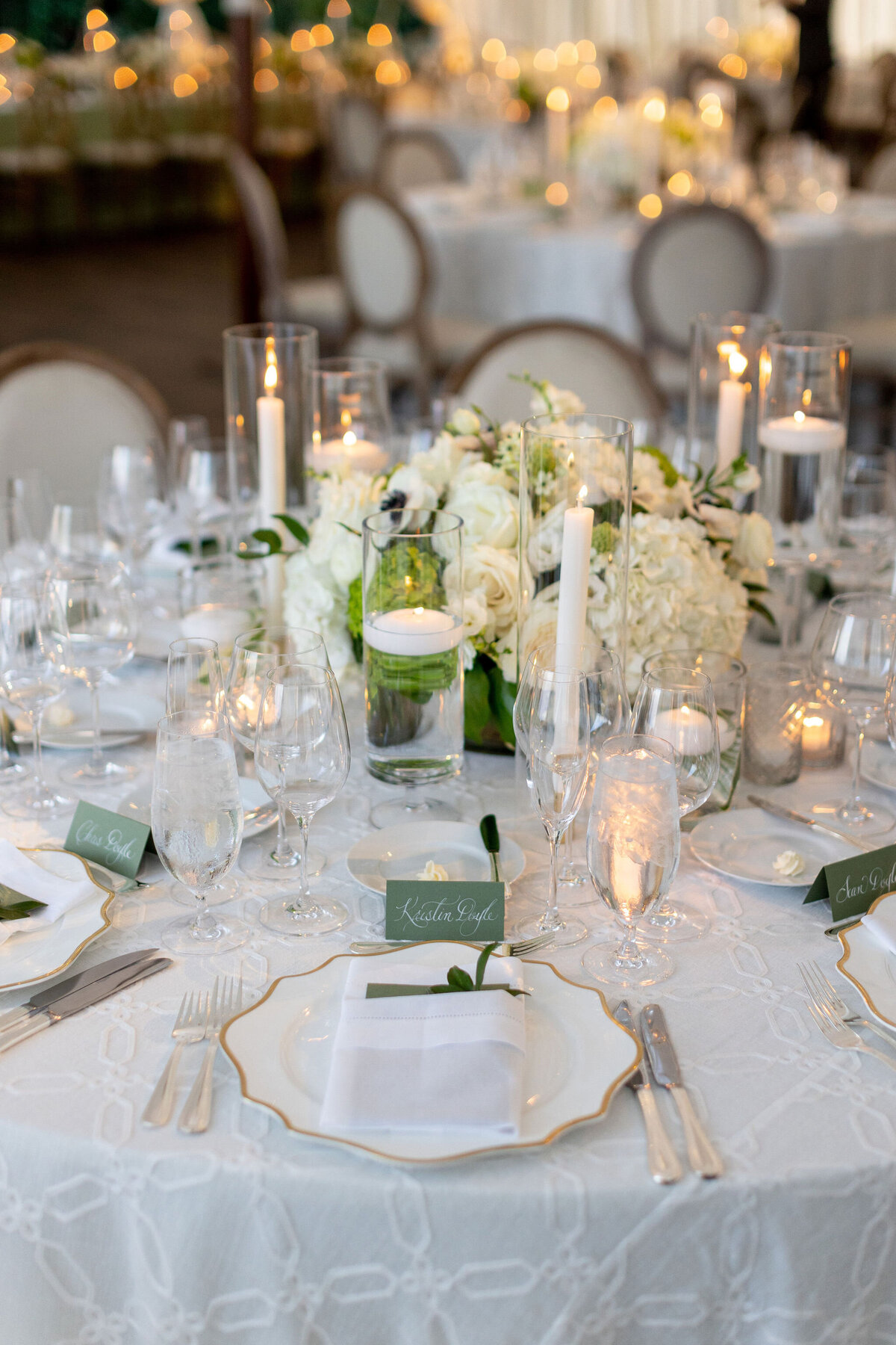 A close up of the place setting and seat assignment cards for the wedding reception. 
