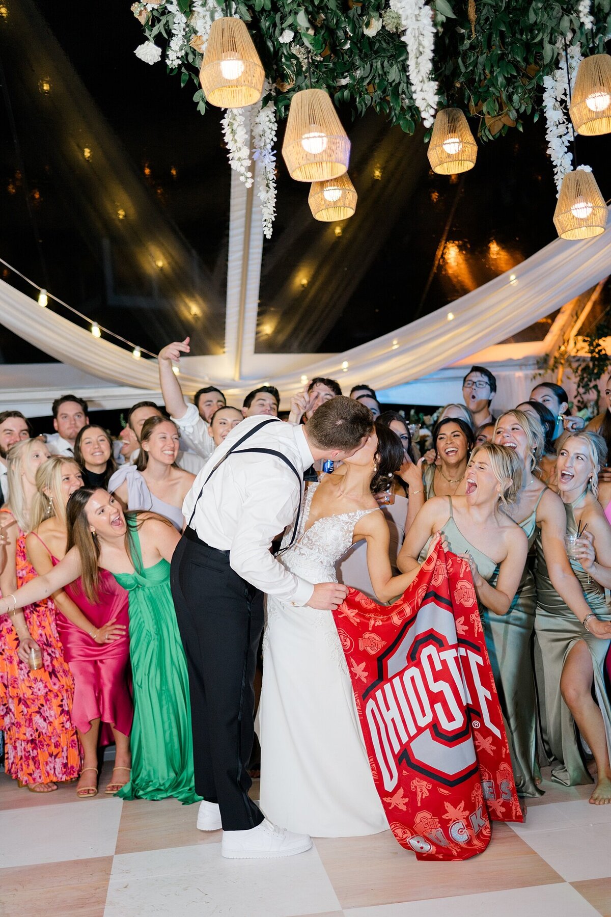 bride and groom kissing during their reception in a tent for a backyard wedding