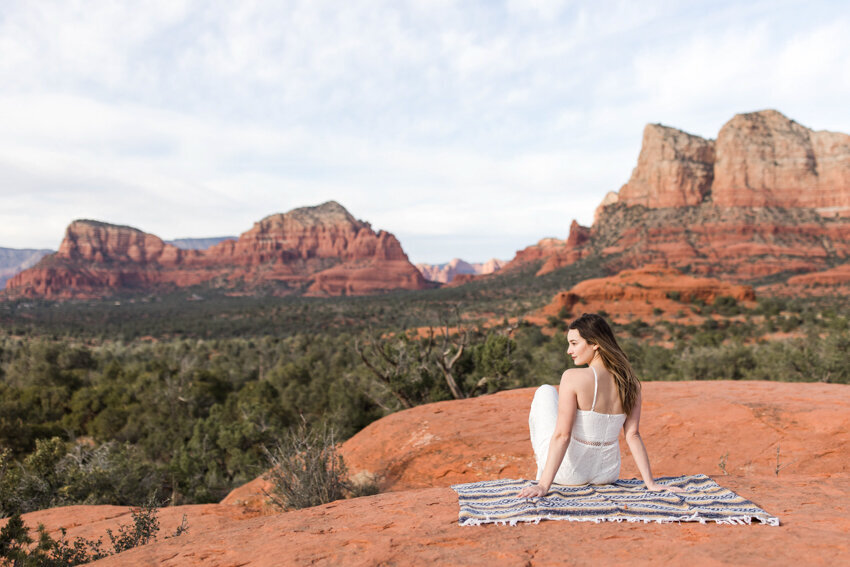 Sedona destination senior session girl sitting on red rock