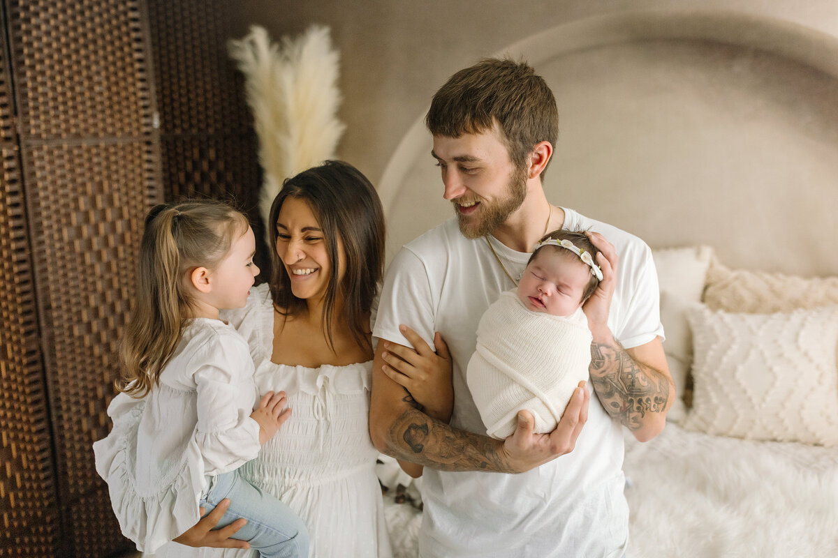 Family laughing at newborn studio