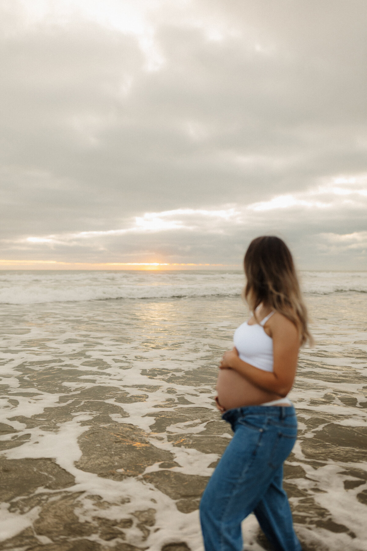 A portrait of a pregnant woman during her maternity beach photoshoot in christchurch
