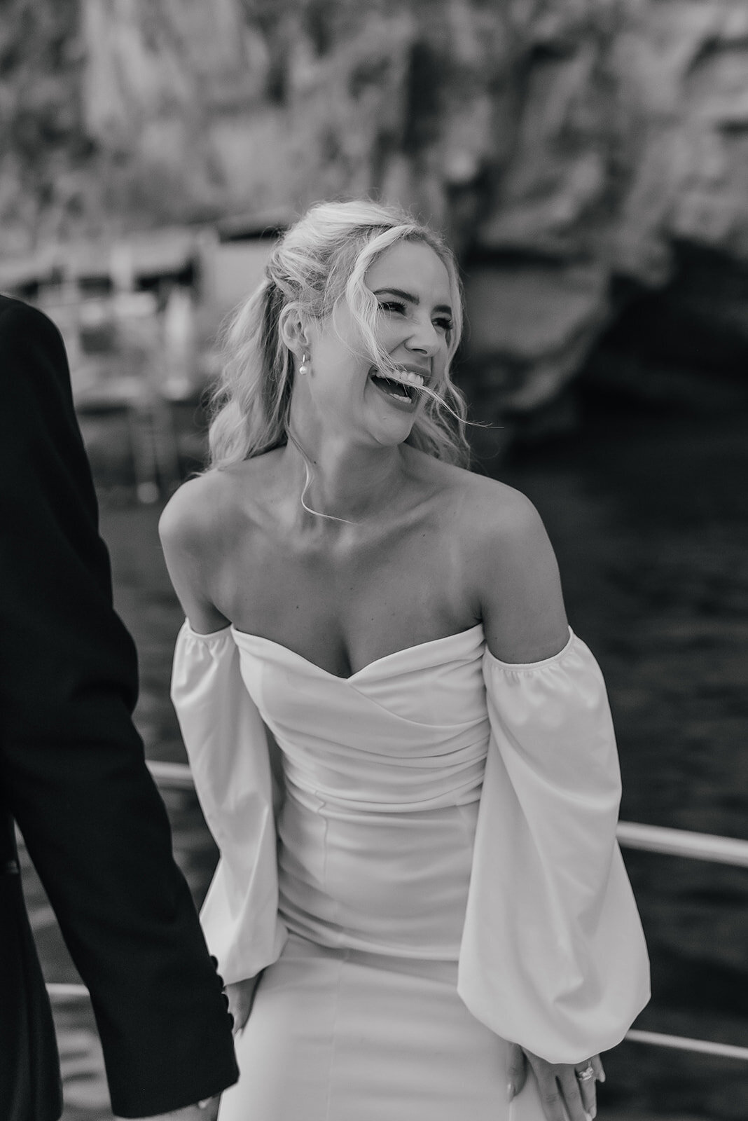 Bride candidly laughing in strapless dress on a boat in Positano Amalfi Coast