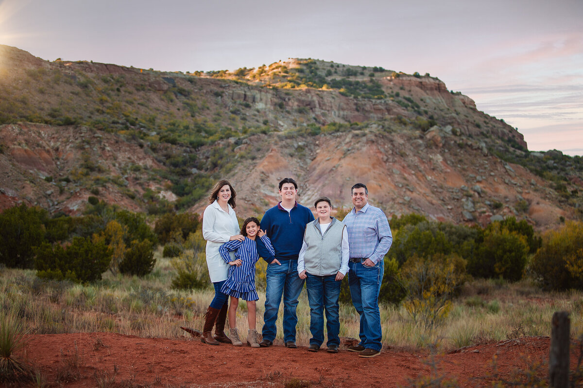 Family standing at Palo Duro canyons sunset