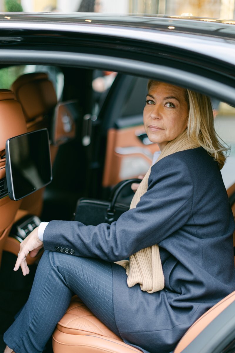 Bespoke luxury wedding planner sitting in a private limousine after a meeting with a client in Vienna 