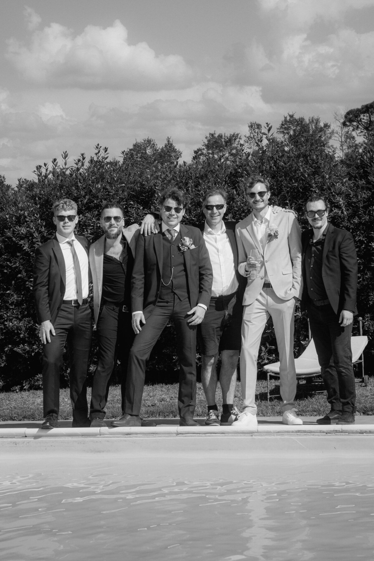 Cool group picture of the groom with his boys, all wearing sunglasses.