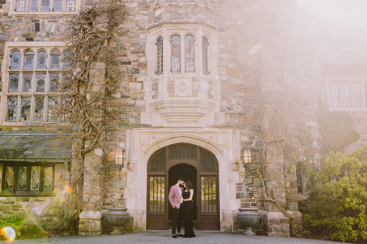 A couple standing in front of the skylands manor mansion in nj wearing black outfit