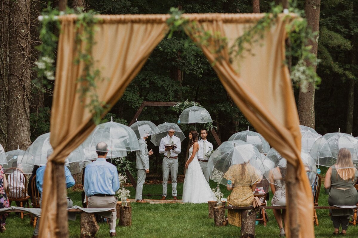 small-intimate-micro-wedding-rainy-umbrellas-thru-loves-lens