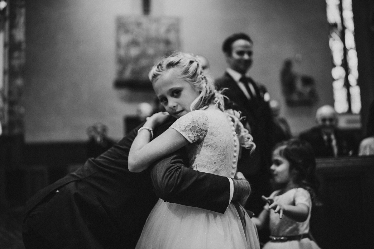 Flower girls hug Groom as they come down aisle at St. Johns Cleveland