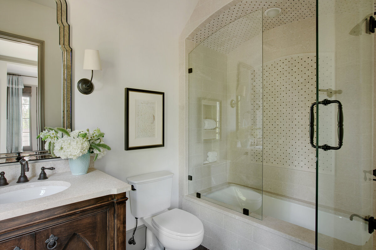 Panageries Residential Interior Design | Traditional Mountain Roost Guest Bathroom Design with Glass Shower Door and Cream Tiles