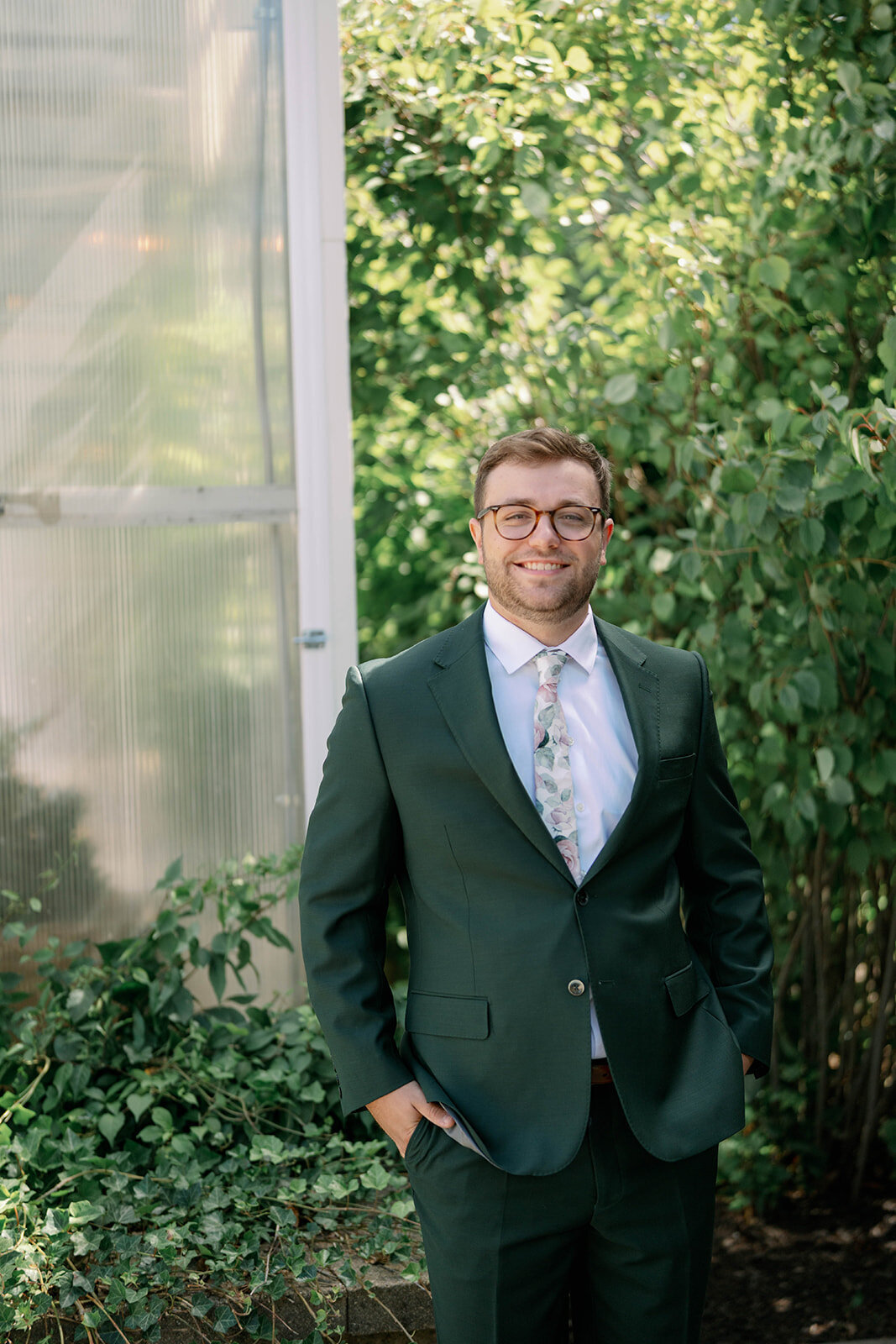 Classic groom portrait taken outside the greenhouse at The Ivy House during a fall wedding in Saugatuck MI.
