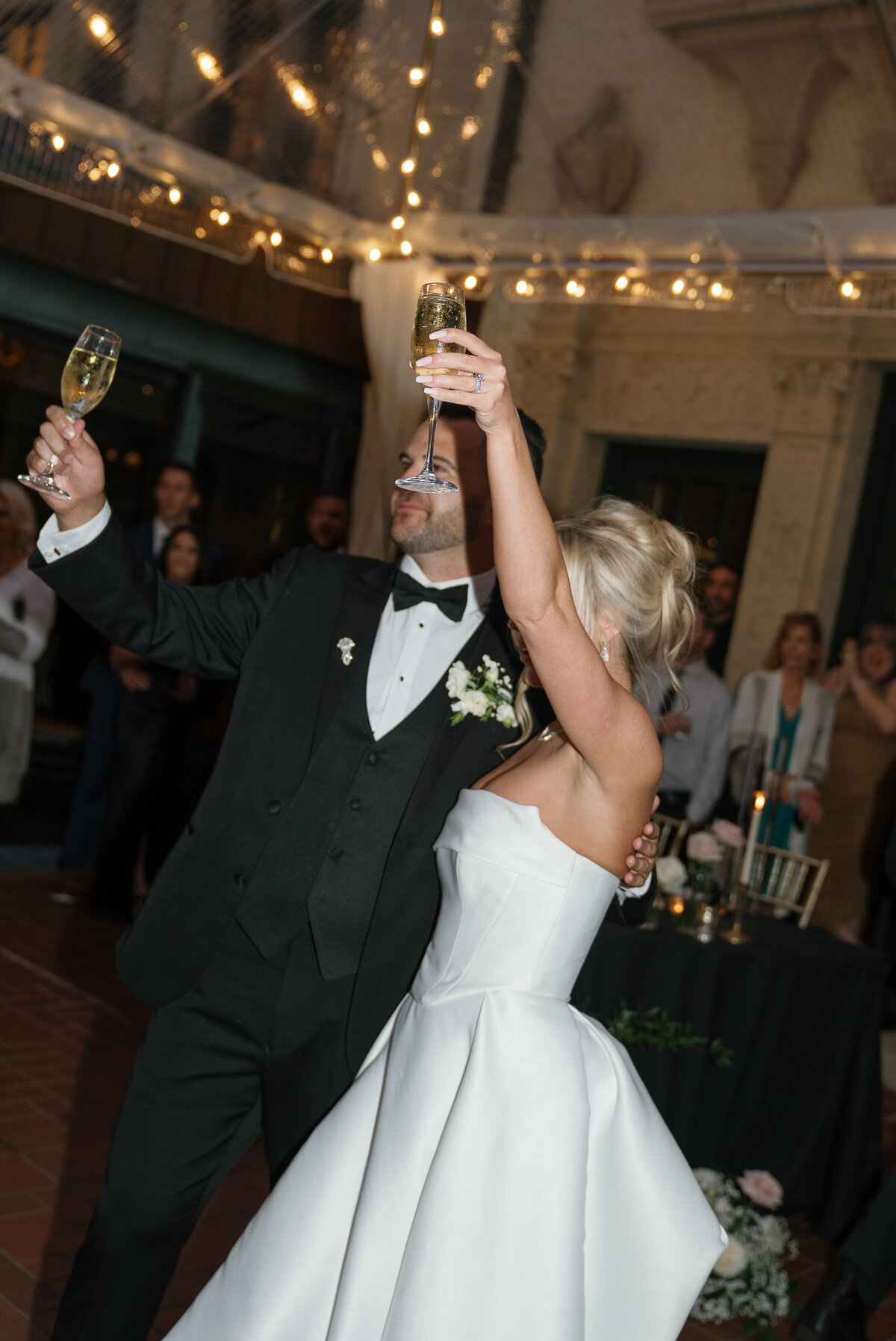 Bride and groom raising their glasses to a wedding toast taken by film style wedding photographer Shelby Ann Photos