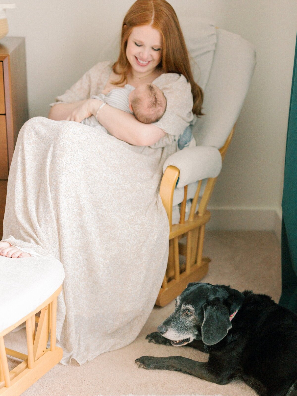 mom-newborn-and-family-dog-in-nursery