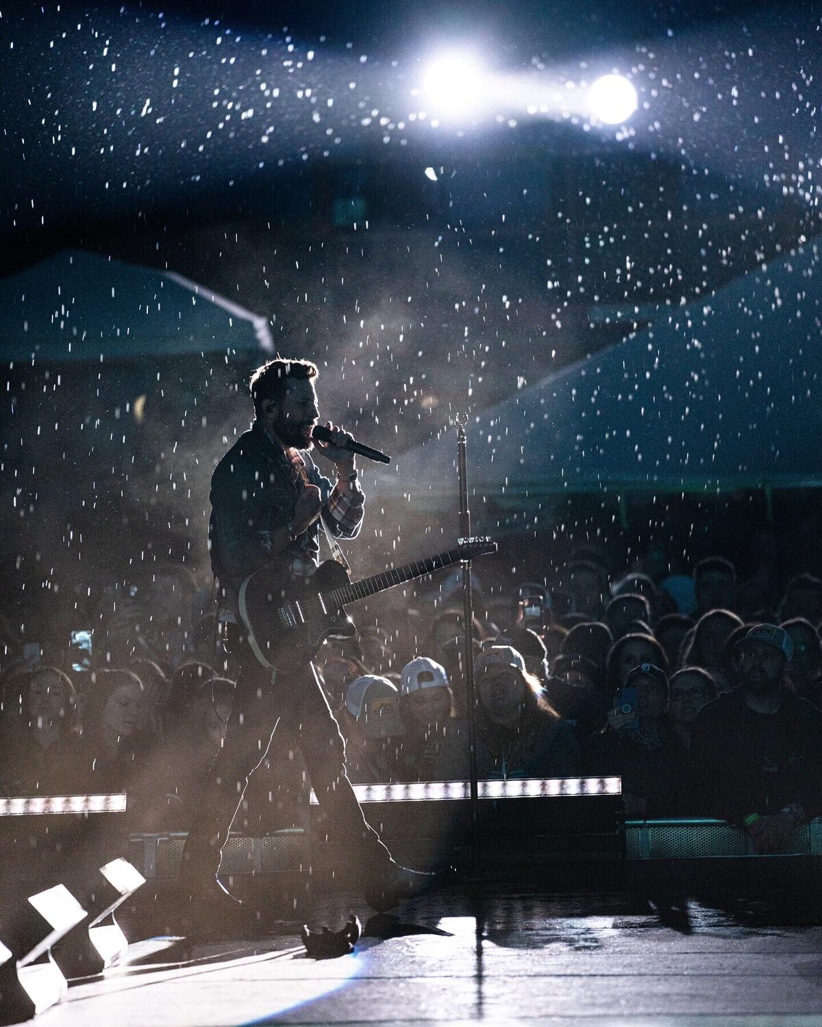 Matthew Ramsey performing in rain during Old Dominion concert