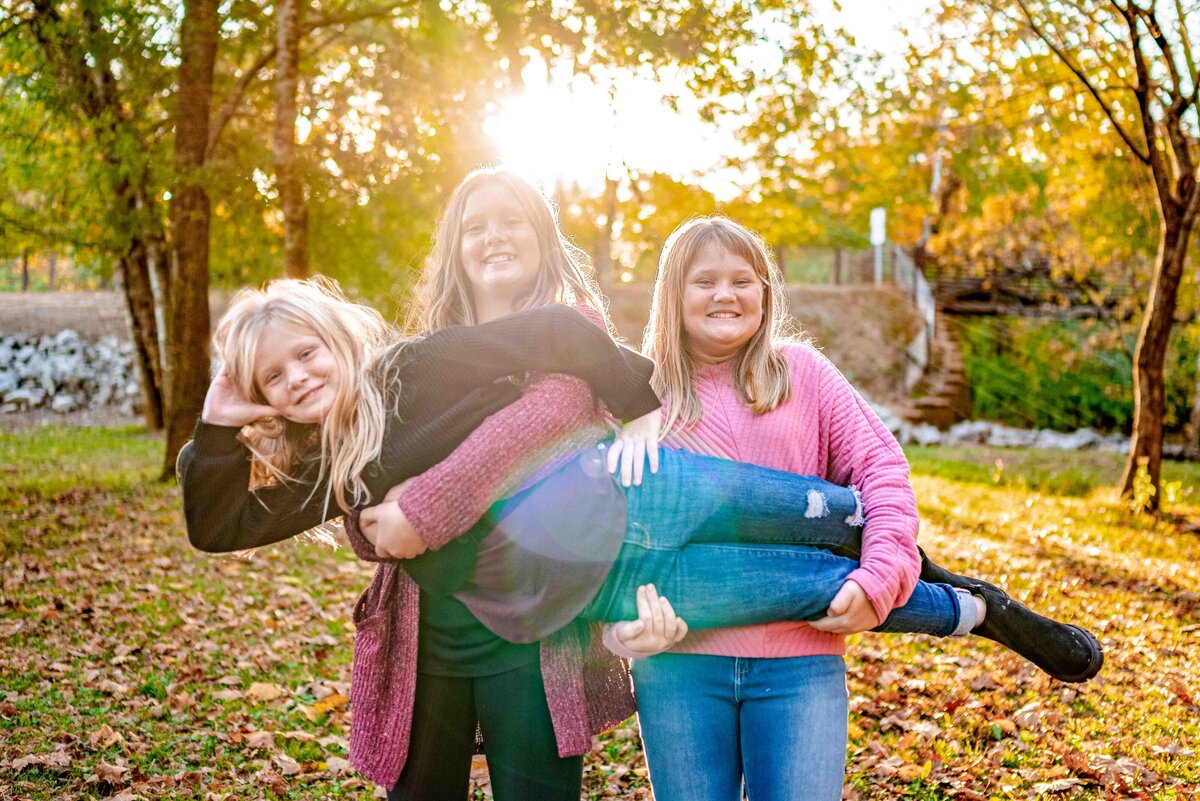 Three sister pose for family photos at Hayes Nature Preserve  in Owens Cross Roads Alabama