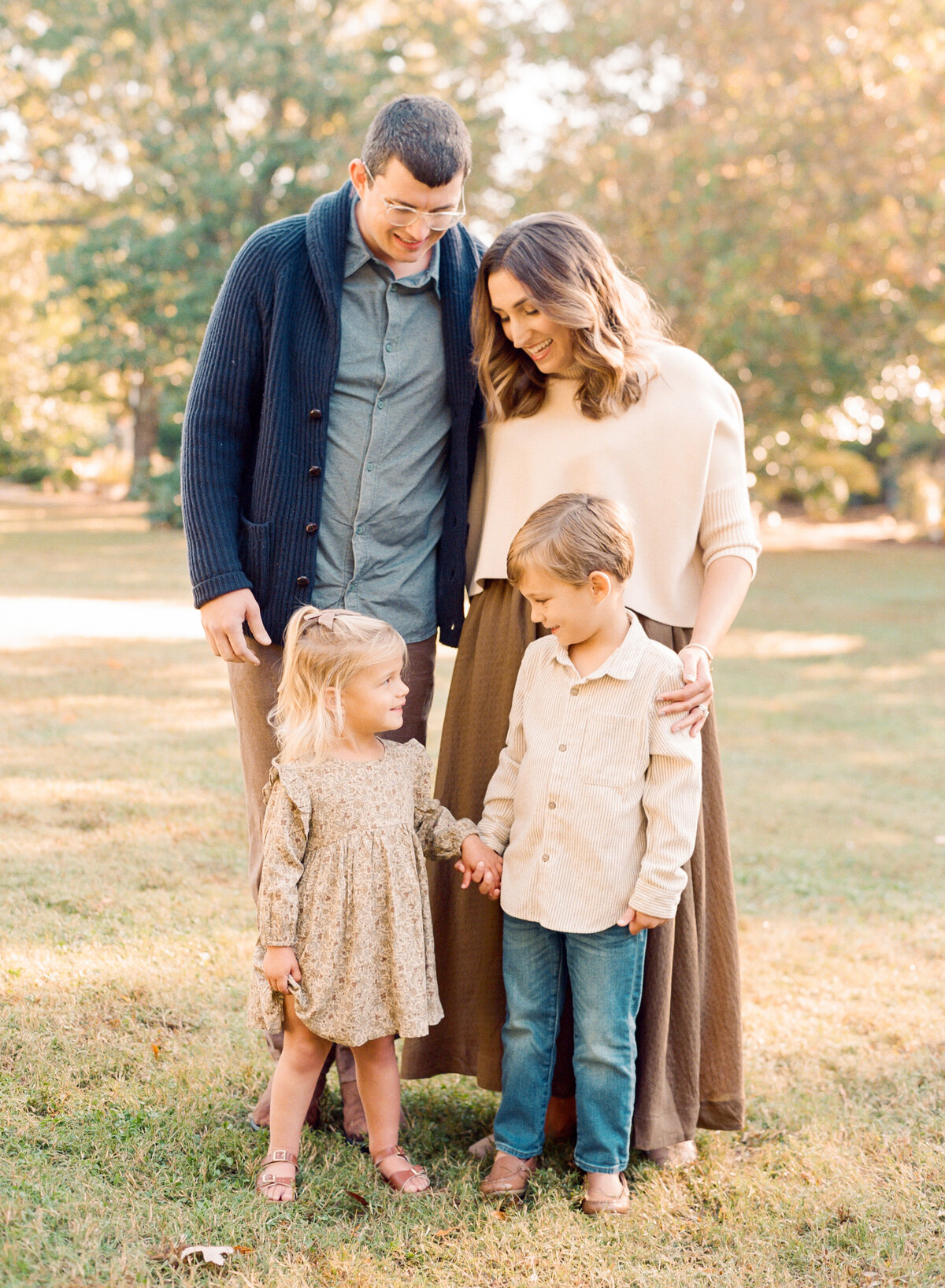 Family of four poses for a portrait. Image by Raleigh maternity photographer A.J. Dunlap Photography.