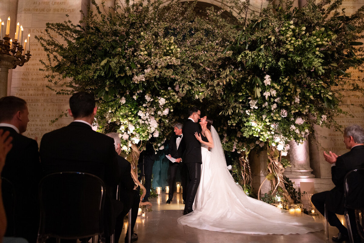 Wedding couple under magical tree alter at the NY Public Library