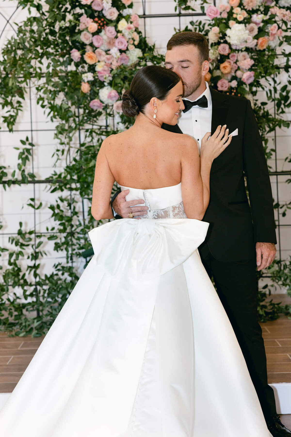 A wedding day photo of the bride and groom posing for a portrait