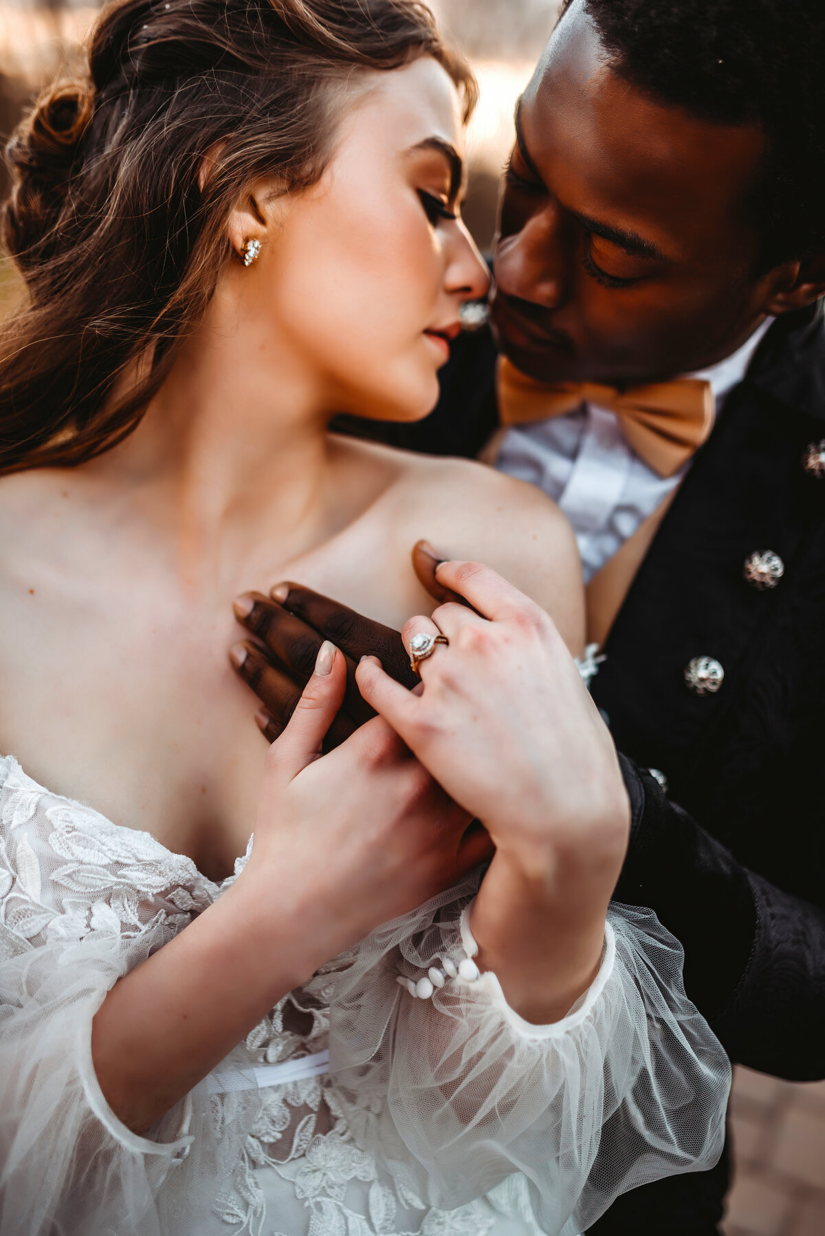 a close up picture of a bride and groom, close up of their hands