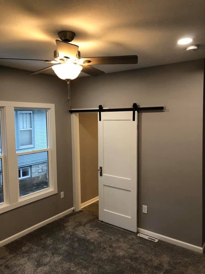 Room with grey walls and sliding white door