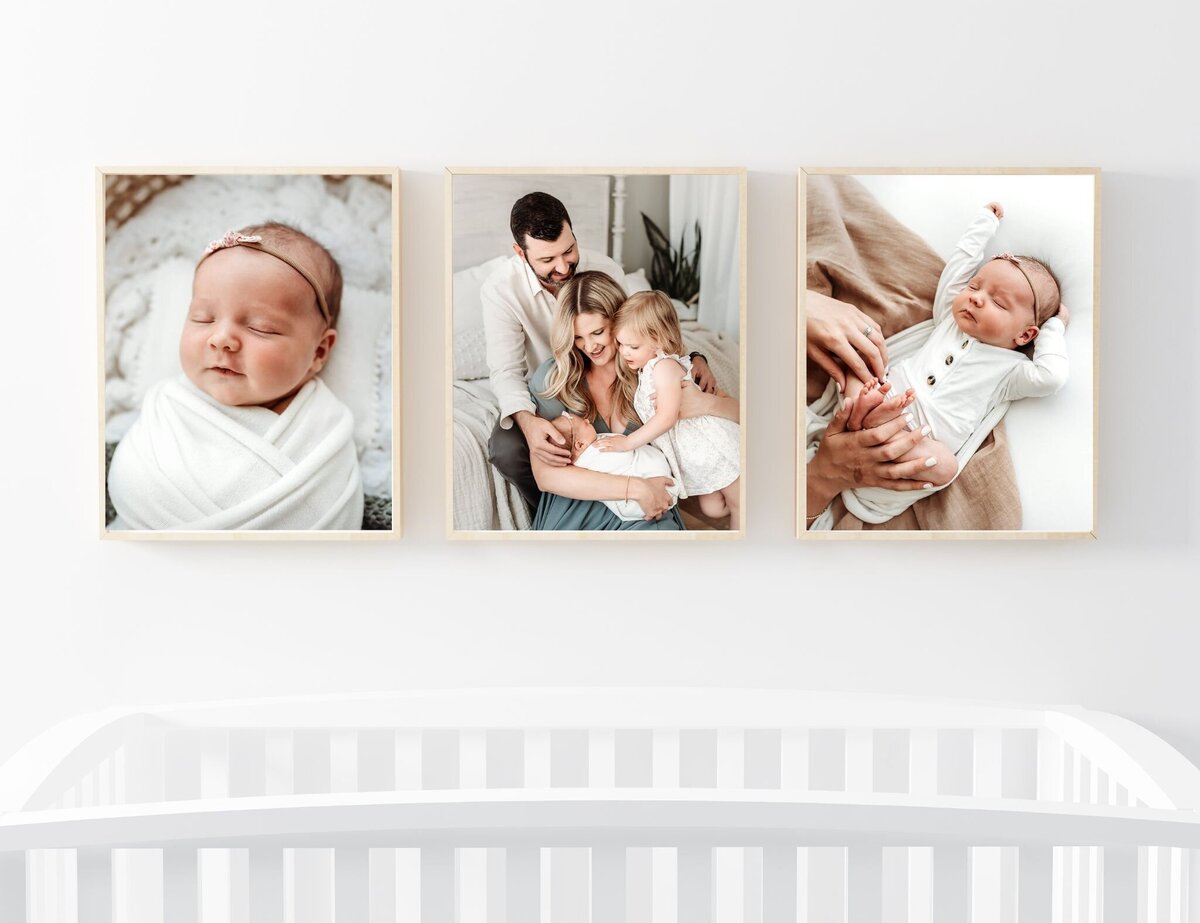 framed newborn photos above crib in nursery