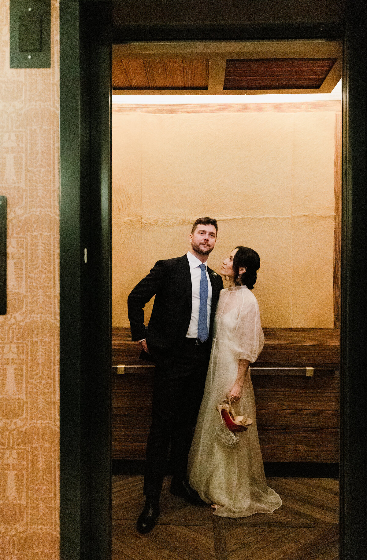 A shot of bride and groom in the mirrow at Proper Hotel Austin