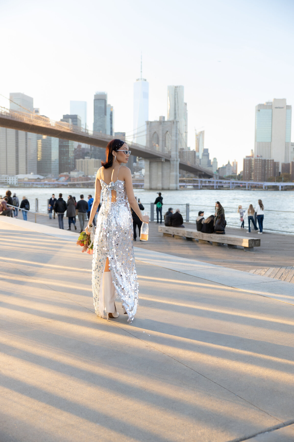 A stylized editorial shot of the couple with the Brooklyn Bridge as the dramatic backdrop in Brooklyn.