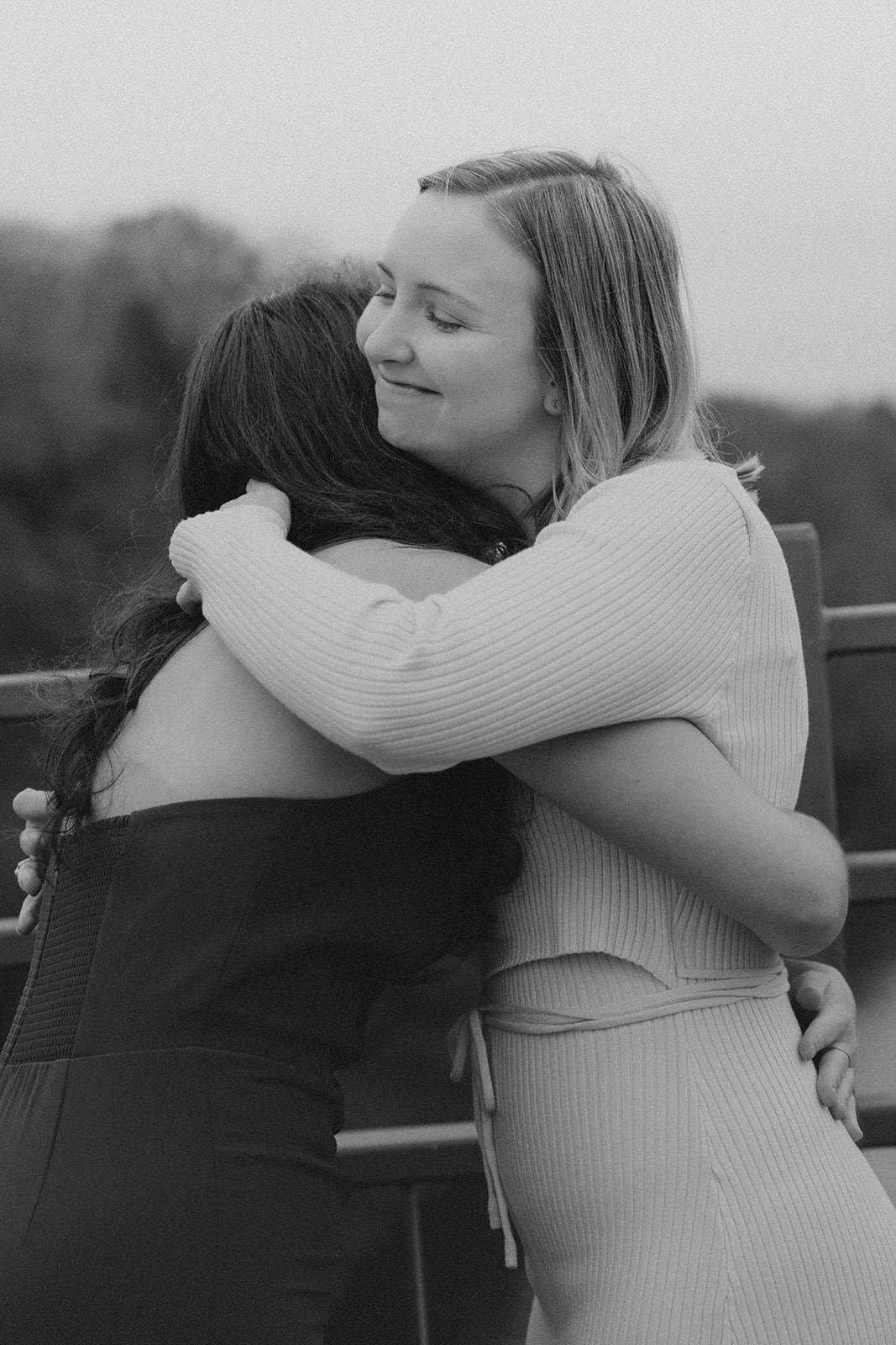 The two new wives embrace after exchanging their vows 