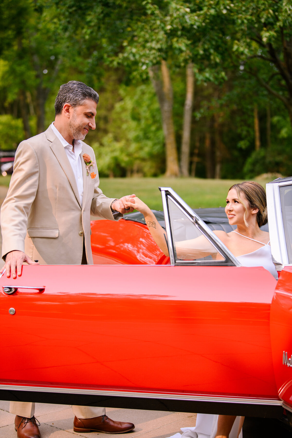 Groom helping Bride out of car