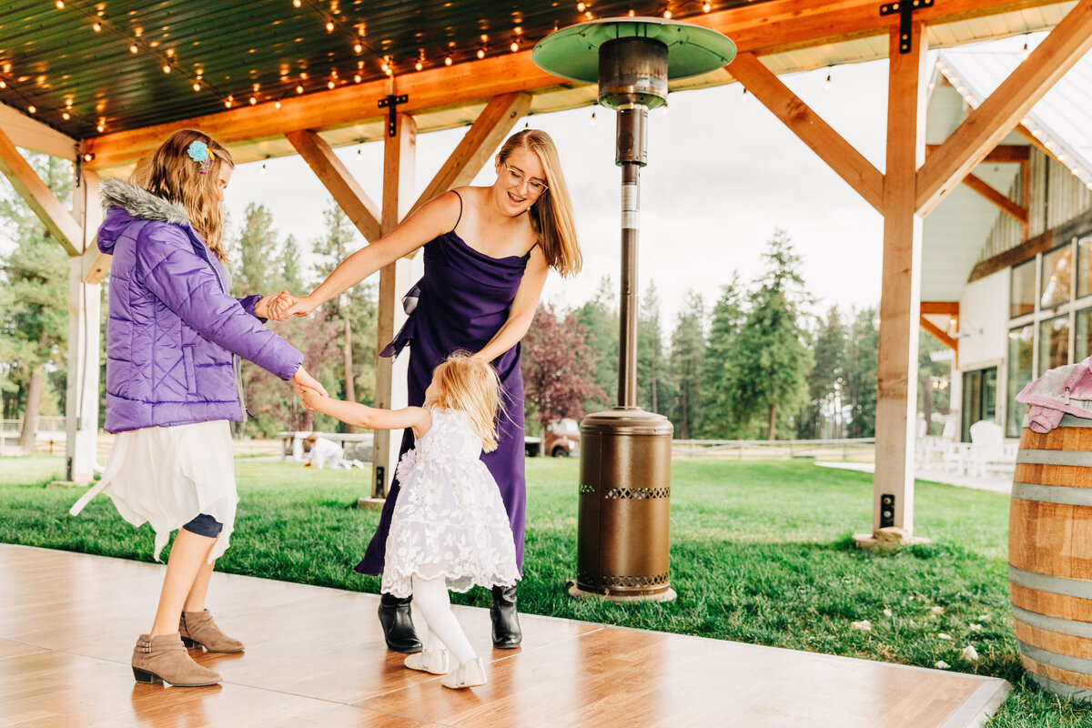Three sisters dancing at The Silver Knot wedding venue in Ronan, MT
