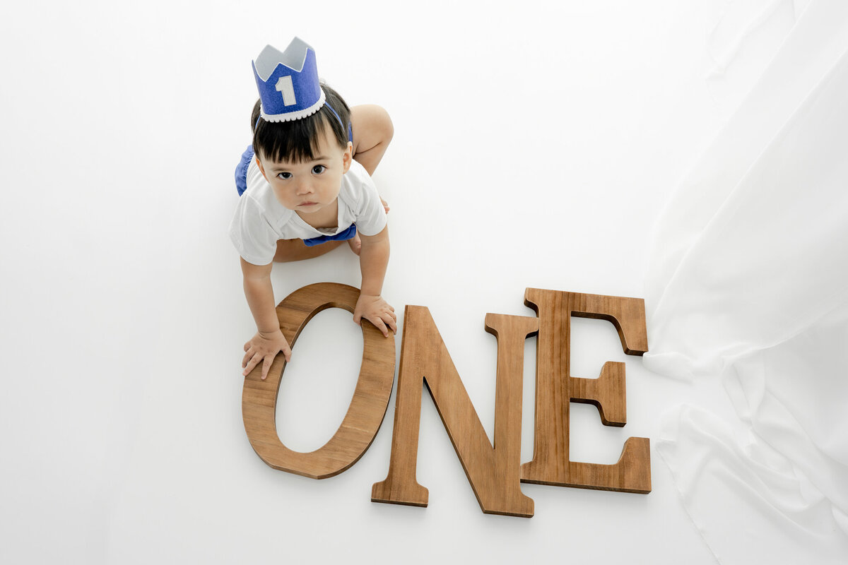 Boy in birthday outfit during themed cake smash session— captured by Alliston and Barrie cake smash photographer.