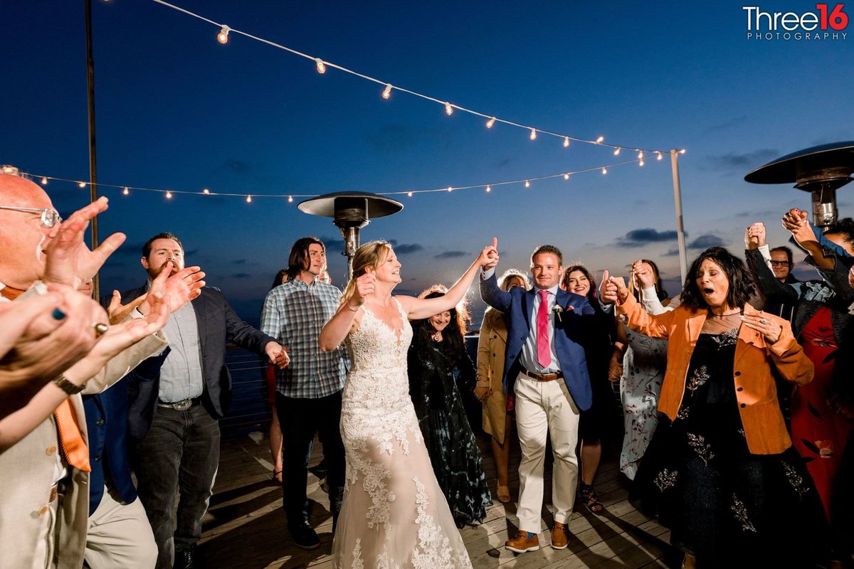 Bride and Groom dance amongst guests under the stars