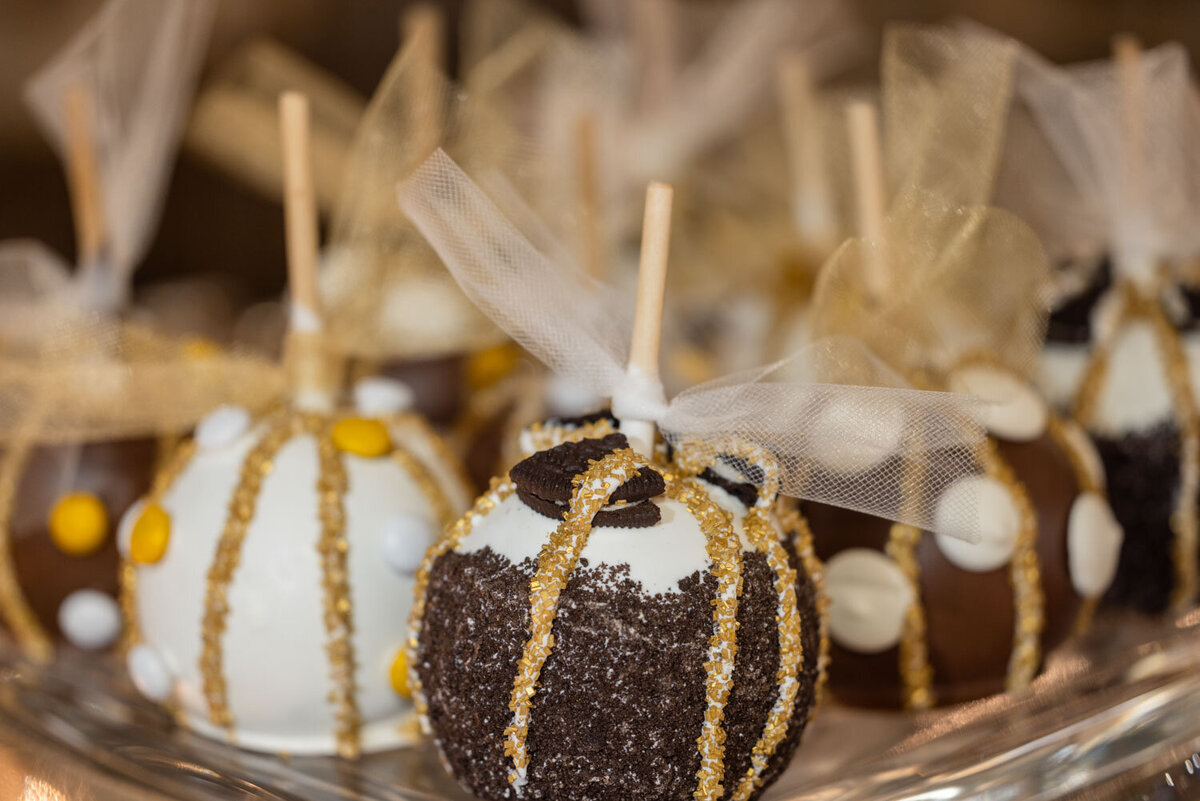 A group of caramel apples are sitting on a glass plate