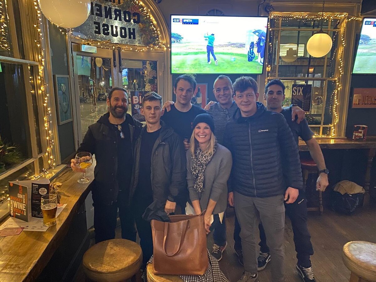 Tourists with off-duty members of the Coldstream Guards at a pub in Windsor, UK