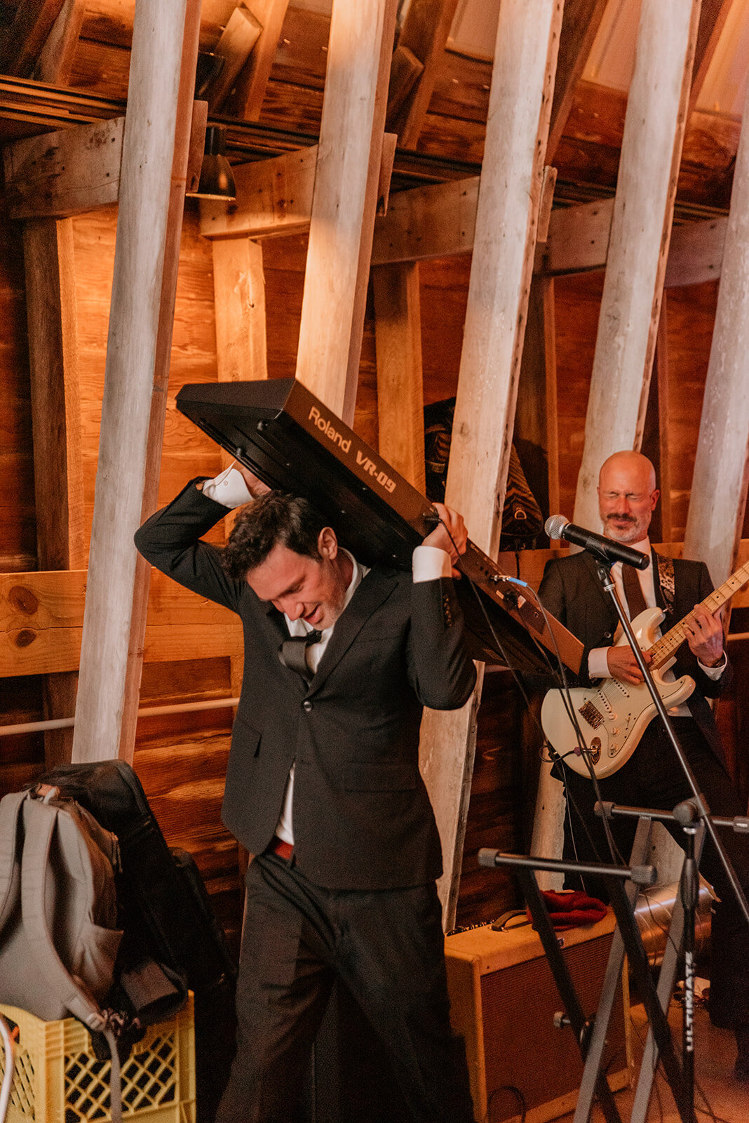 Live band playing keyboard on a guest’s head at Glenwood Mountain wedding.

