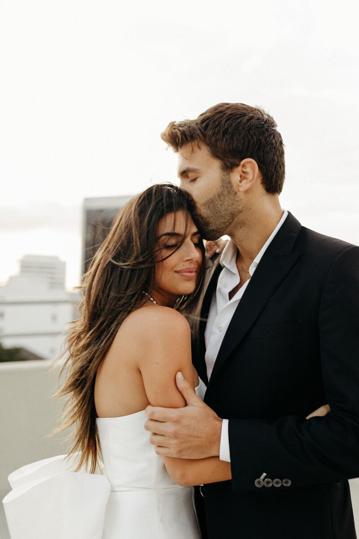 Couple kissing on rooftop for engagement photography in orlando