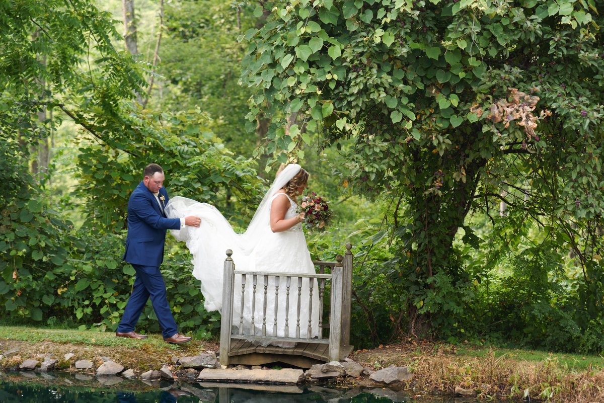 Couple Crossing Bridge Pond