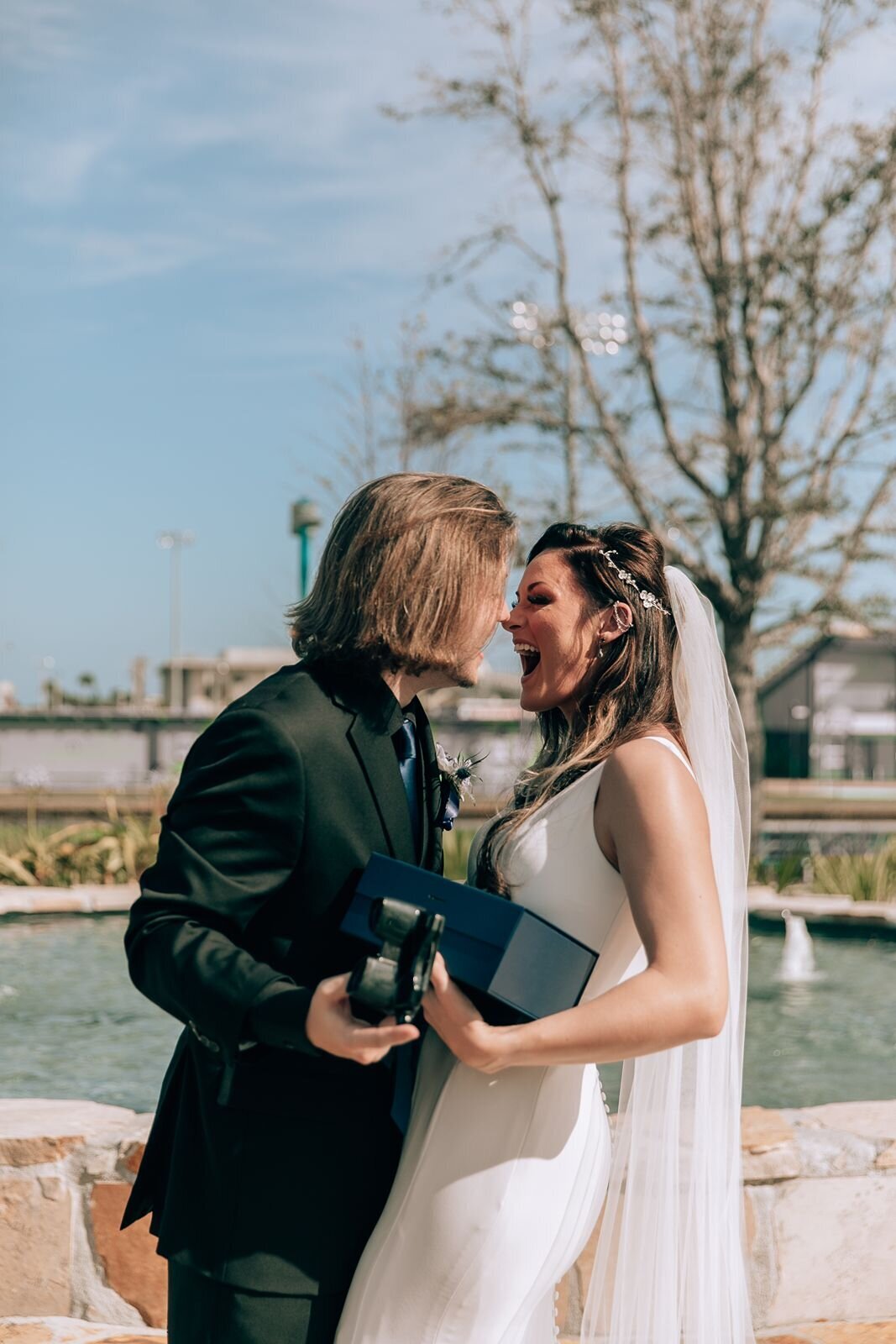 bride and groom are exited about their gifts to eachother