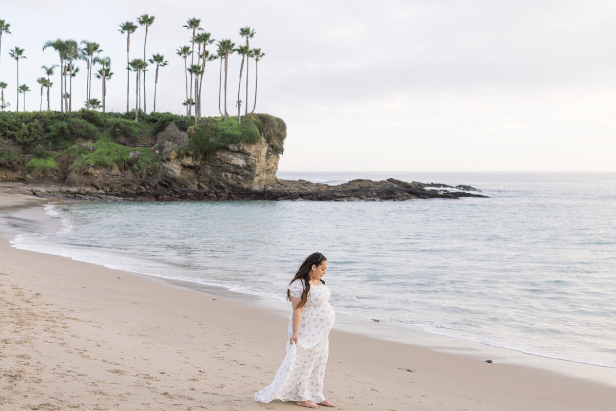 candid maternity photo on the beach