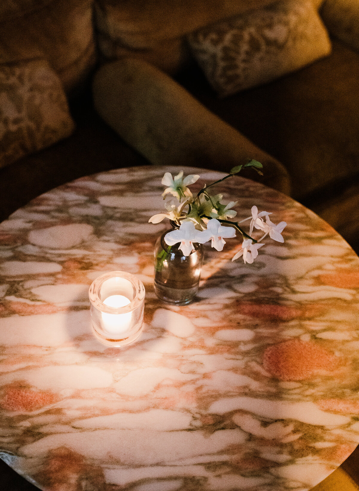 A candle and florals on a table at the Proper Hotel Austin