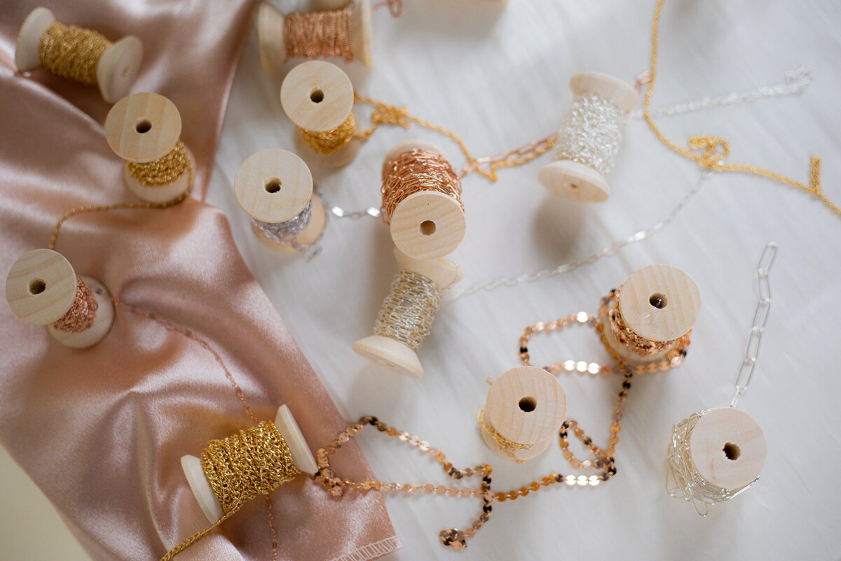 Beautiful display of permanent jewelry chains available at Jazzy's Glam Bar