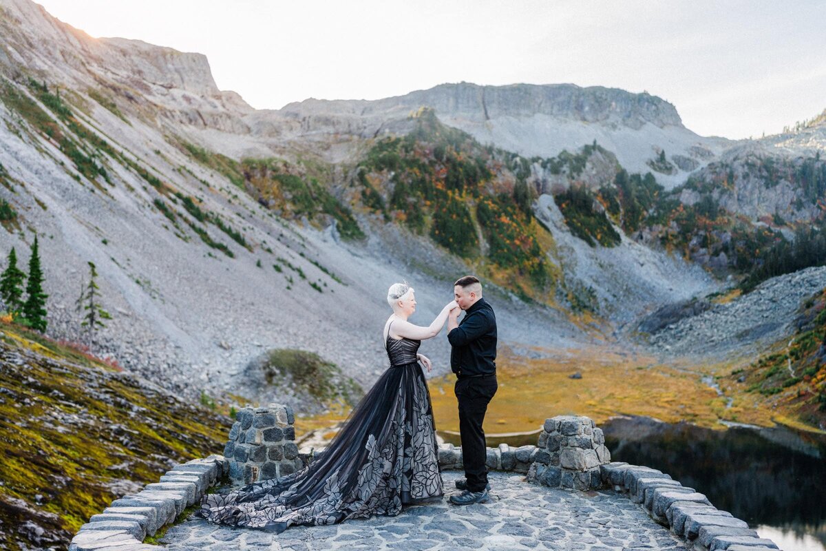 A Groom kissing his brides hand in Heather Meadows during their North Cascades Elopement.