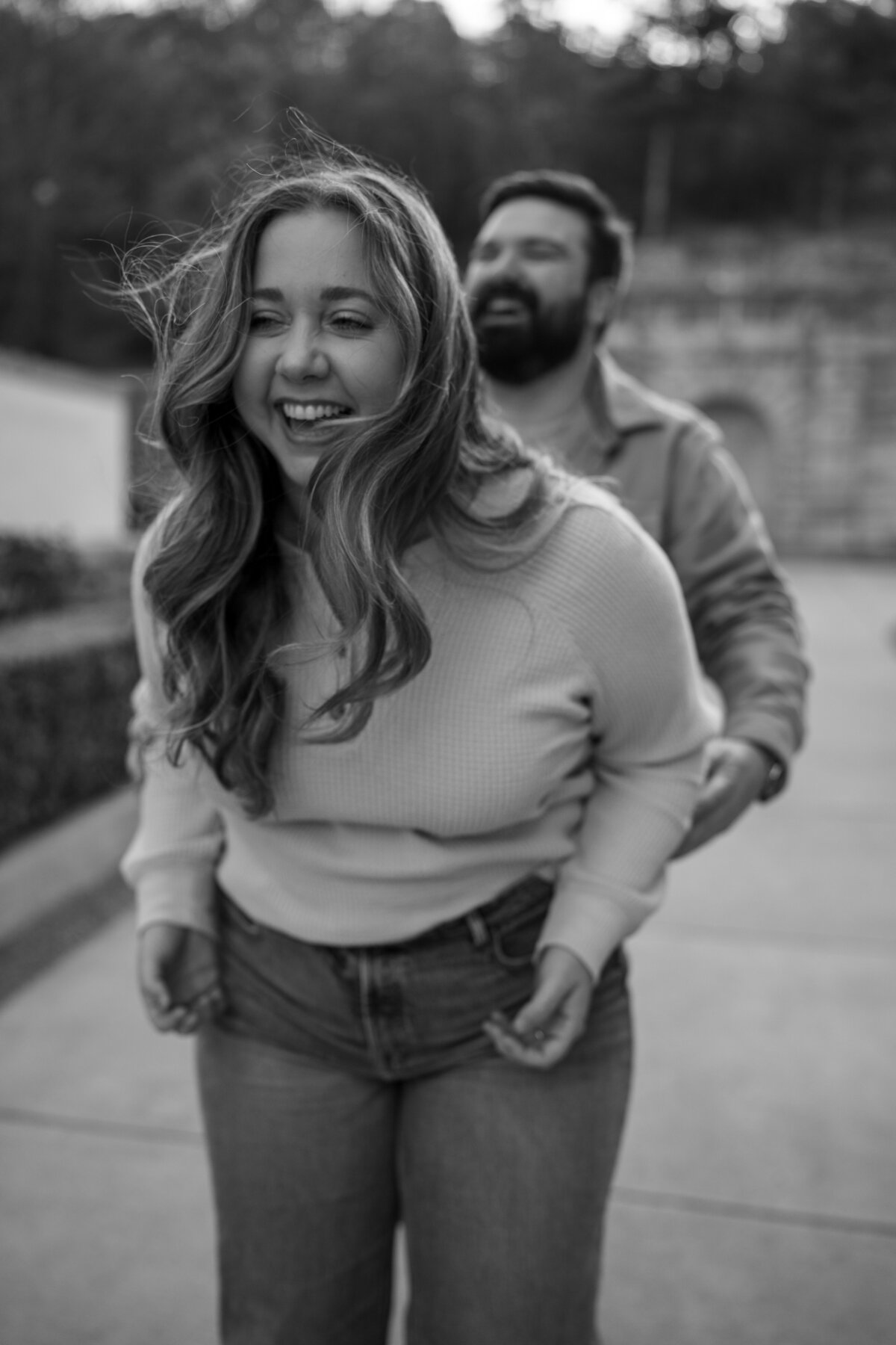 couple playing and laughing in downtown hot springs