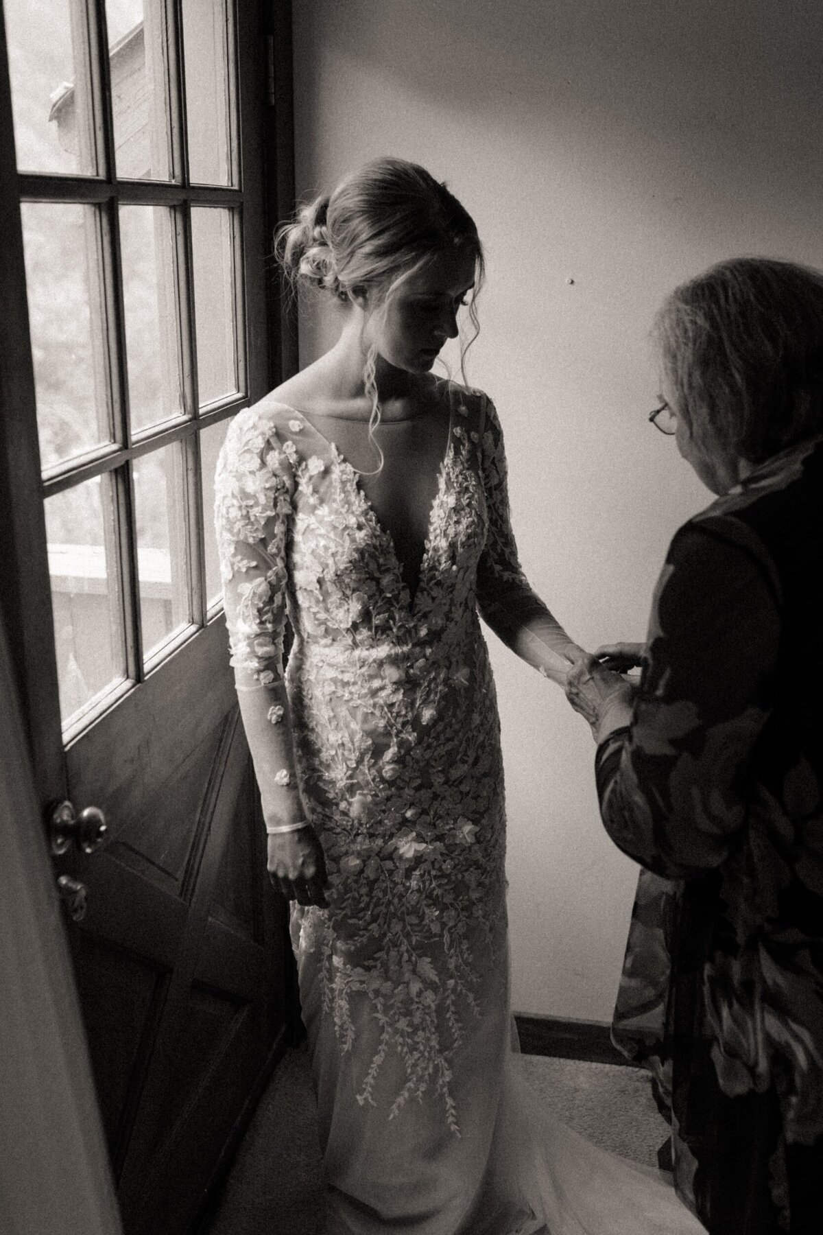 A bride getting help with her jewerly by her grandma in Colorado